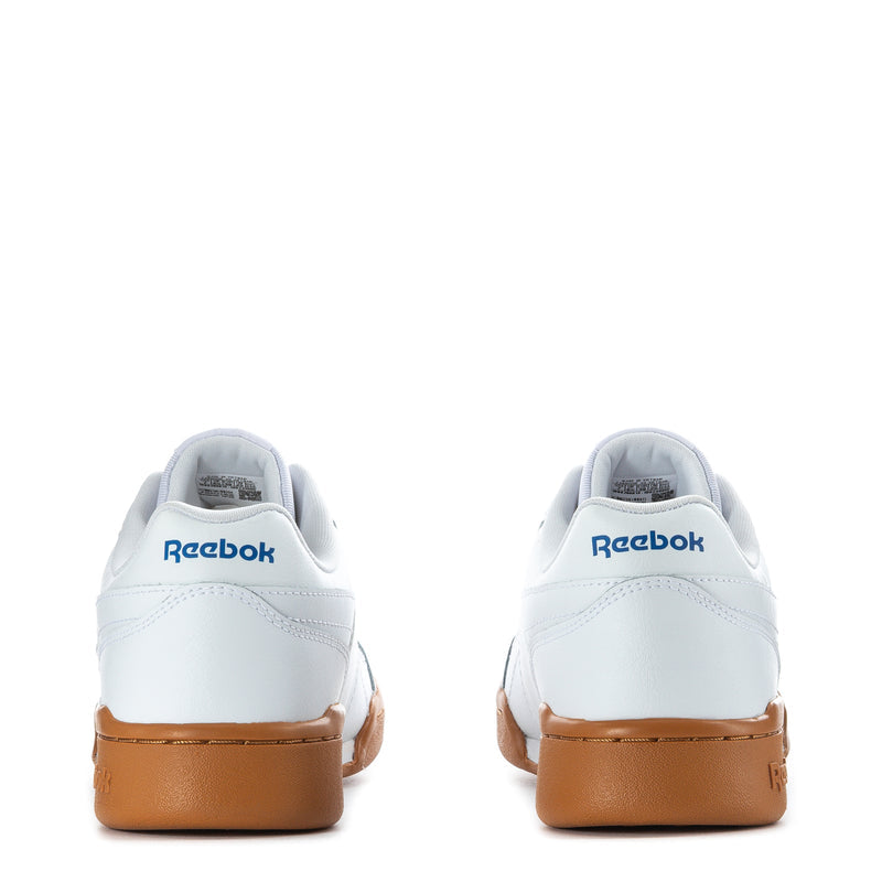 Back view of white youth Reebok lace-up sneakers with gum heel and rear logo.